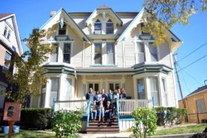 Group standing in front of a house